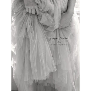 black and white fine art print, close up of hands holding tulle skirt, softness, 