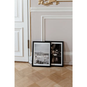 Paris rooftops, grey skies, view over rooftops towards Sacré-Couer church, fine art print, framed fine art print leaning against other print and ornamental wall with gold details and partially shown door, Paris, French interior