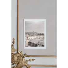 Load image into Gallery viewer, Paris rooftops, grey skies, view over rooftops towards Sacré-Couer church, fine art print, white borders, on ornamental wall with golden details, French, Paris interior
