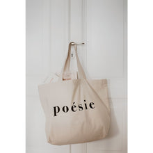 Load image into Gallery viewer, natural organic bag with the word poésie printed in large letters in middle, hanging from a door handle against white door, tow French books inside, Gallimard and Astier de Villatte
