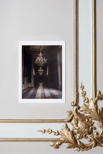 Load image into Gallery viewer, chandeliers in palace interior, French interior, Paris, brown shades in background, herringbone floors, soft light, fine art print with white borders on ornamental wall with gold details
